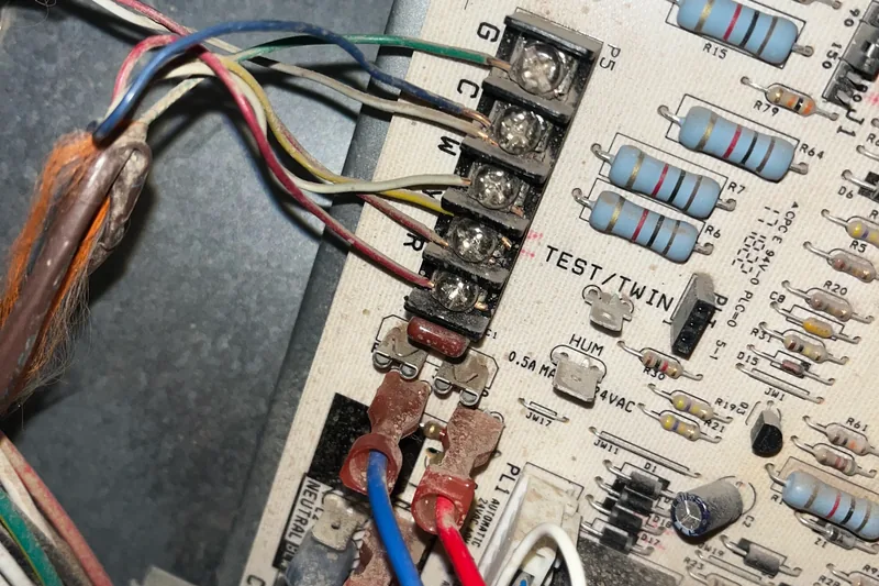 Digital multimeter testing on solid-state inverter control board and electronic microprocessor