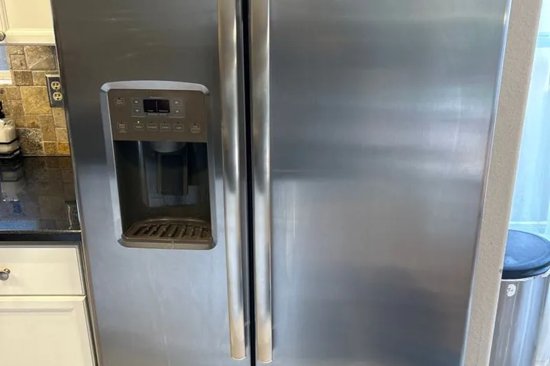 Side-by-side built-in refrigeration temperature control and water valve service